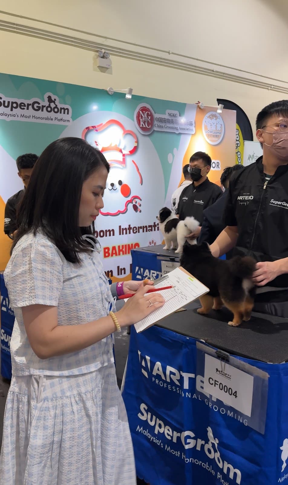 Ms. Selly judging grooming competition — photo 1